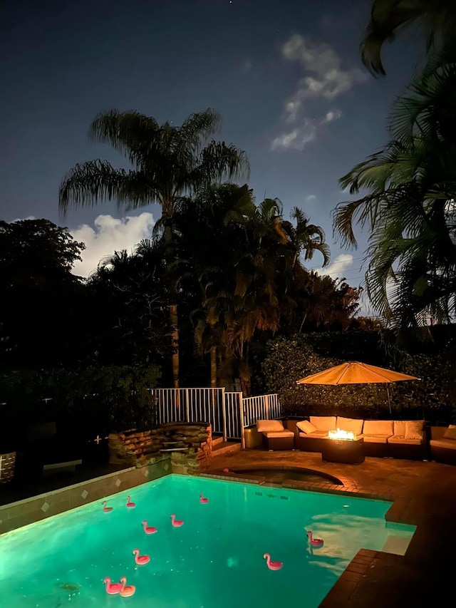 view of pool with a patio and an outdoor fire pit