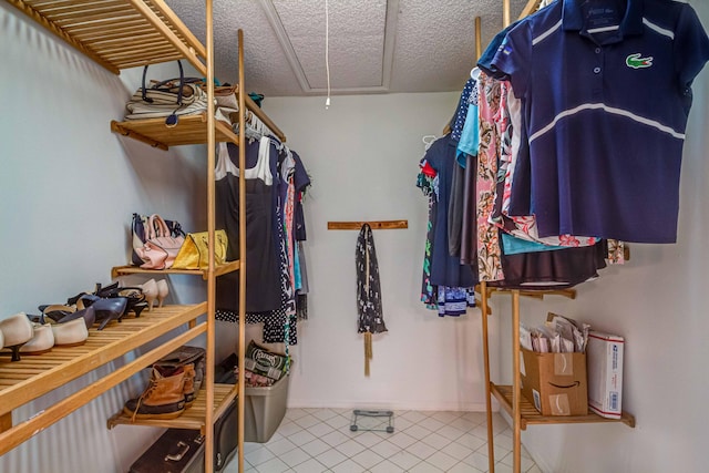 spacious closet with light tile patterned floors