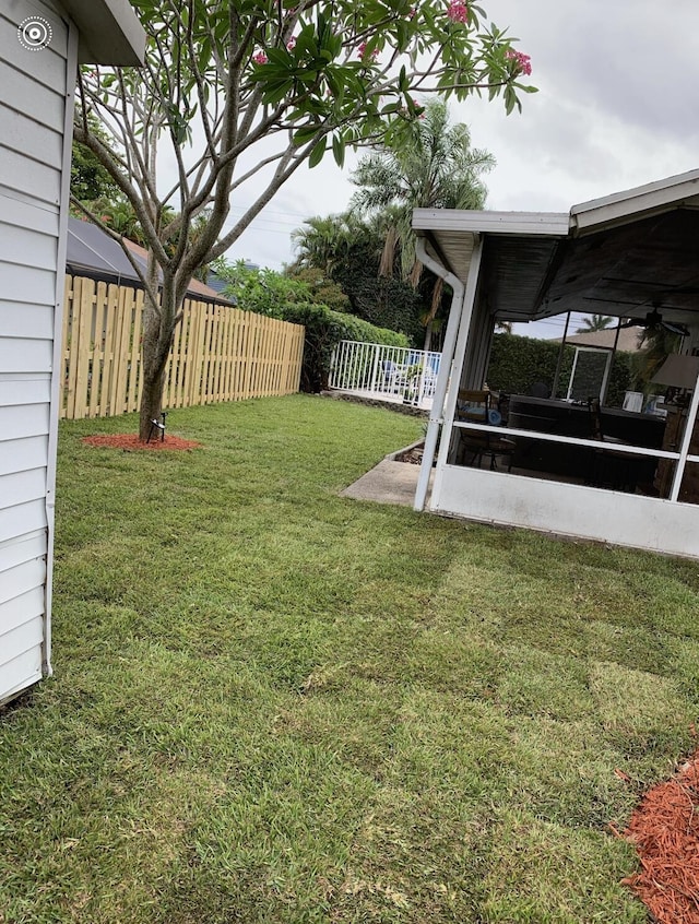 view of yard with a sunroom