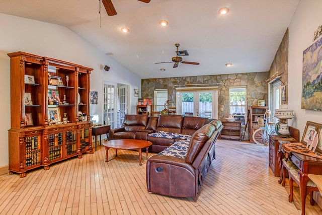 living room featuring french doors, light wood-type flooring, ceiling fan, and lofted ceiling