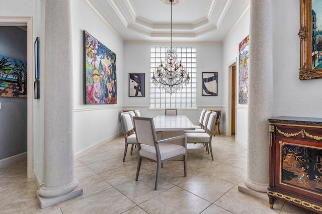 dining space with decorative columns, ornamental molding, a tray ceiling, a notable chandelier, and light tile patterned flooring