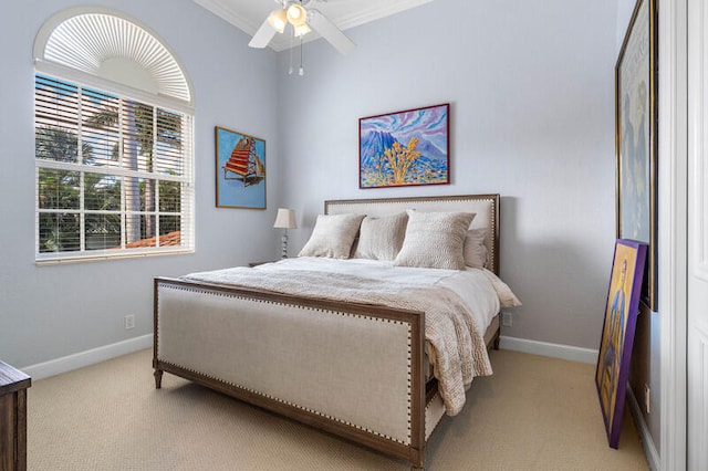 bedroom featuring light carpet, ceiling fan, and crown molding