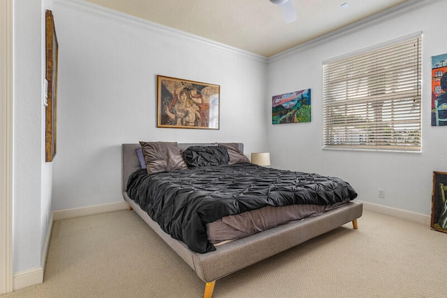 bedroom featuring ceiling fan, ornamental molding, and carpet floors