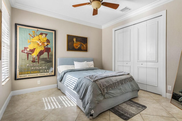 tiled bedroom with ceiling fan, crown molding, and a closet