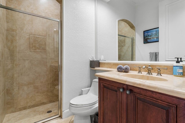 bathroom with toilet, vanity, and walk in shower