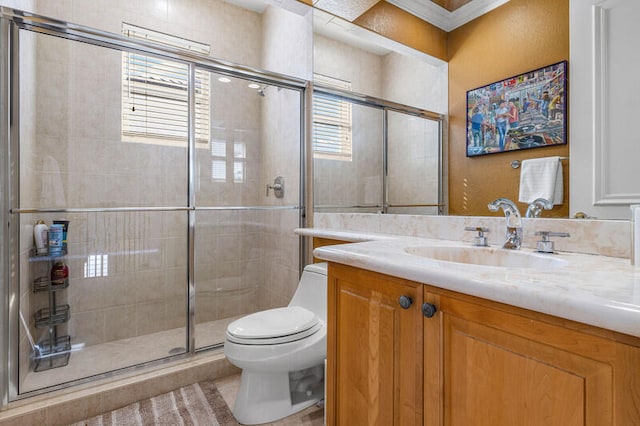 bathroom featuring vanity, tile patterned floors, crown molding, toilet, and a shower with shower door