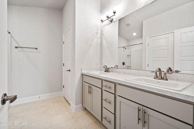 bathroom with vanity and walk in shower