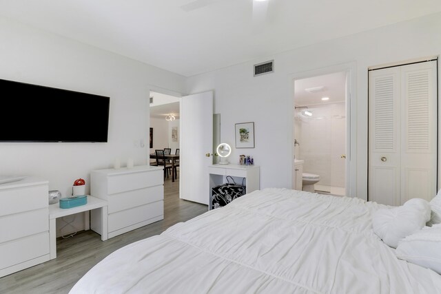 bedroom with dark hardwood / wood-style floors