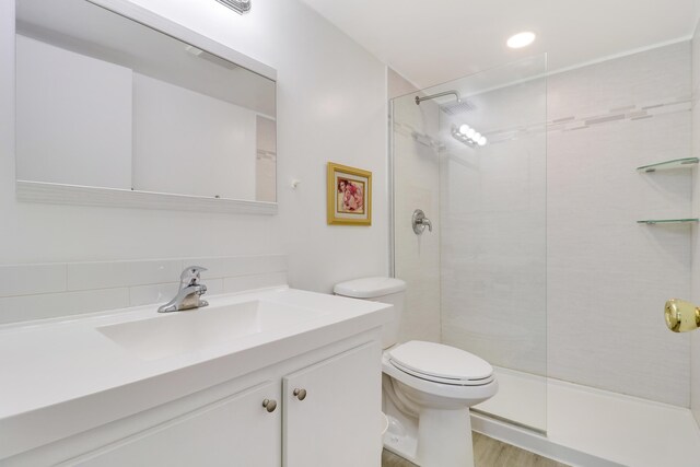 bathroom featuring hardwood / wood-style flooring, vanity, and toilet