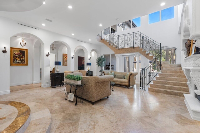 living room featuring a towering ceiling and an inviting chandelier