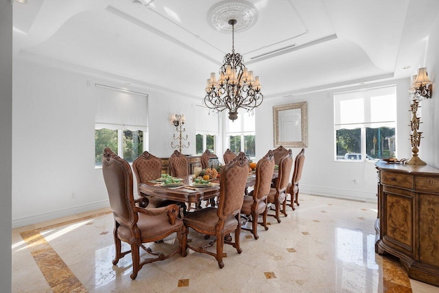 dining room featuring a chandelier and a tray ceiling