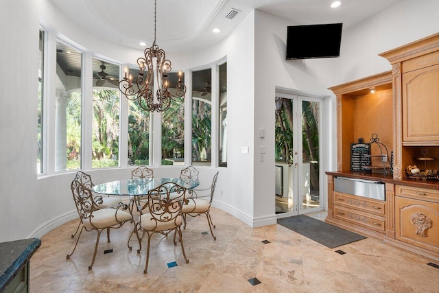 dining room featuring french doors and a notable chandelier