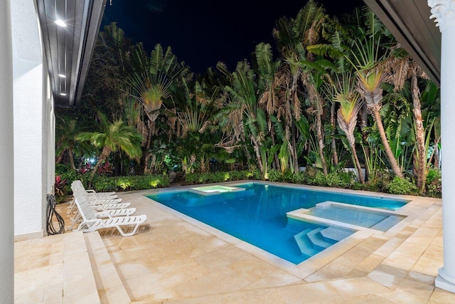 view of pool featuring an in ground hot tub and a patio