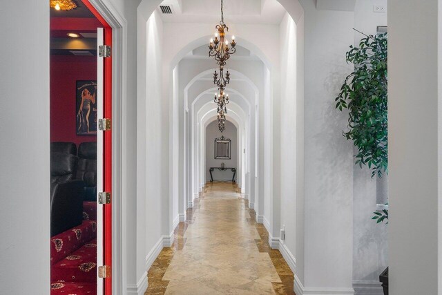 corridor with a chandelier