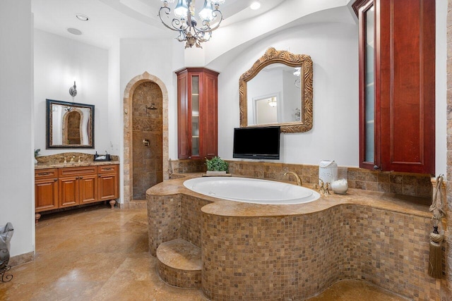 bathroom featuring vanity, separate shower and tub, and a chandelier