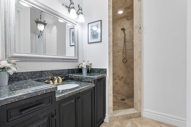 bathroom with vanity and tiled shower