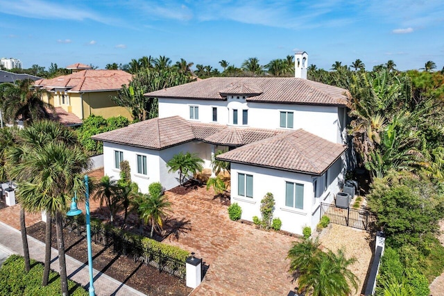 mediterranean / spanish-style house featuring central AC unit