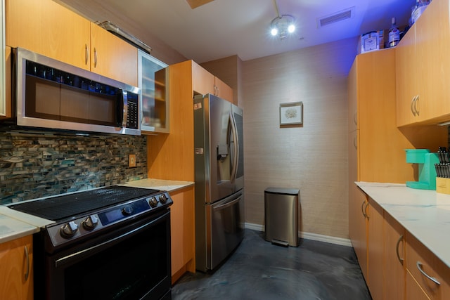 kitchen featuring appliances with stainless steel finishes, tasteful backsplash, and light stone counters