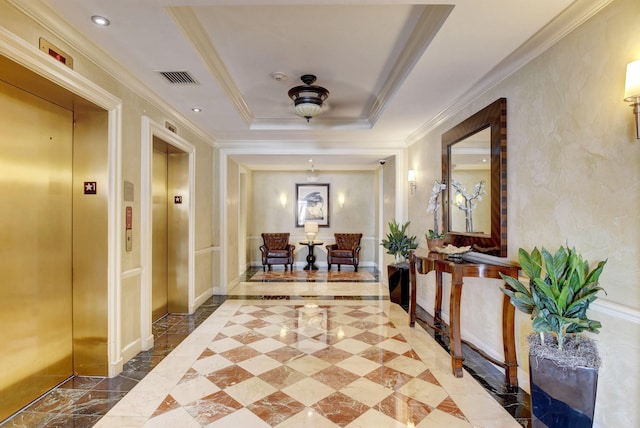 hallway featuring a tray ceiling, elevator, and ornamental molding