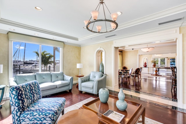 living room featuring hardwood / wood-style floors, ornamental molding, and a chandelier