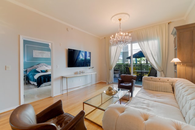 living room with light wood-type flooring, ornamental molding, and a notable chandelier