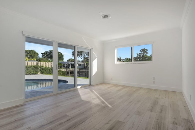 unfurnished room with light hardwood / wood-style flooring and ornamental molding