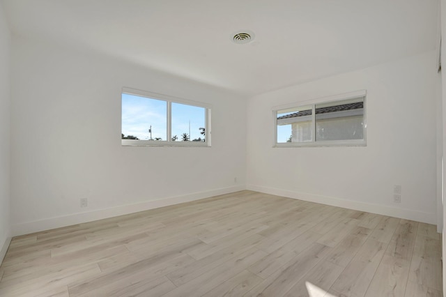 empty room with light hardwood / wood-style flooring