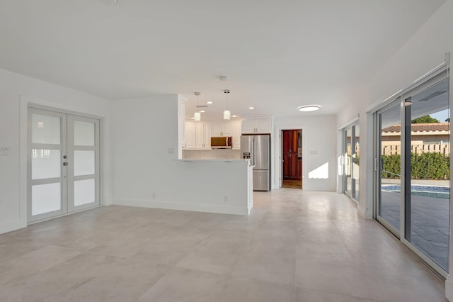 unfurnished living room featuring french doors