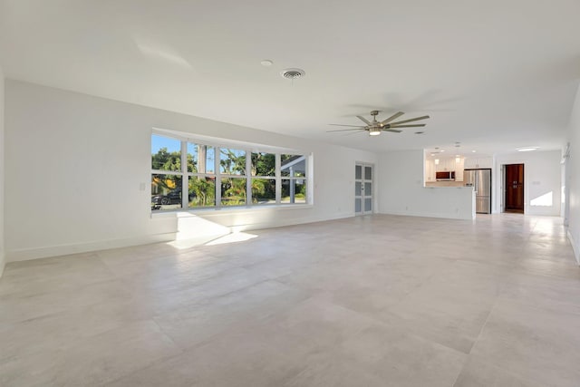 unfurnished living room with ceiling fan