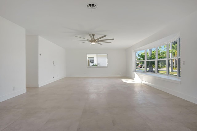 unfurnished room featuring ceiling fan and a healthy amount of sunlight