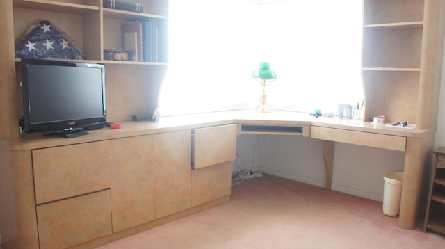 carpeted home office with built in desk