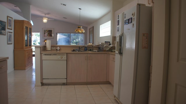 kitchen featuring white appliances, vaulted ceiling, a healthy amount of sunlight, and sink