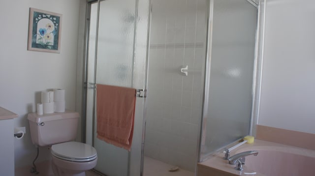 bathroom featuring independent shower and bath and toilet