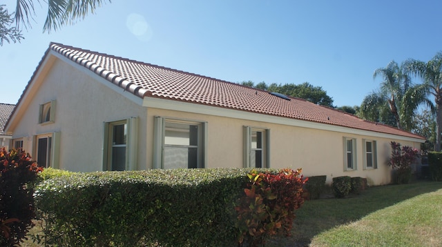 view of side of property with a lawn