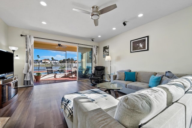 living room with dark hardwood / wood-style floors and ceiling fan