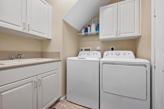 washroom featuring cabinets, sink, separate washer and dryer, and light tile patterned flooring