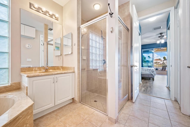 bathroom with tile patterned floors, ceiling fan, vanity, and an enclosed shower