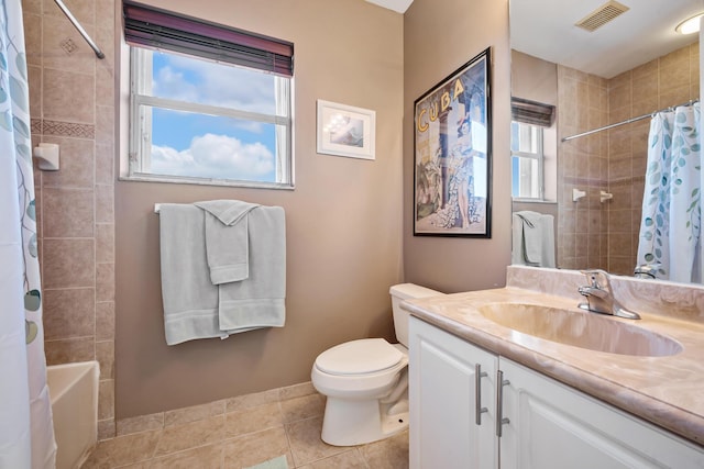 full bathroom with tile patterned floors, shower / bath combo with shower curtain, vanity, and toilet