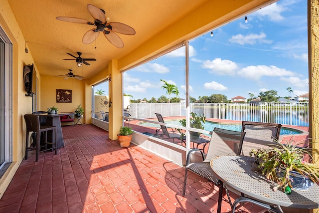 view of patio / terrace featuring a water view and ceiling fan