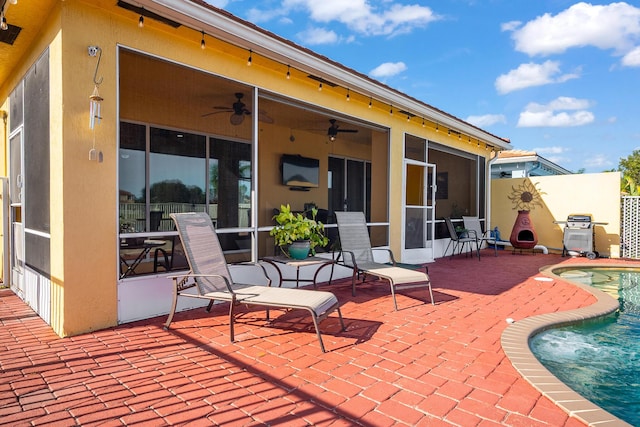 view of patio with a fenced in pool, a sunroom, ceiling fan, and grilling area