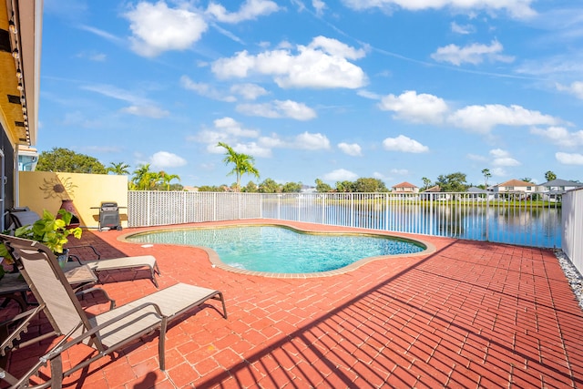 view of swimming pool featuring a water view and a patio area