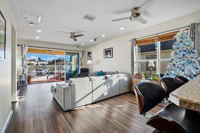 living room with hardwood / wood-style floors and ceiling fan