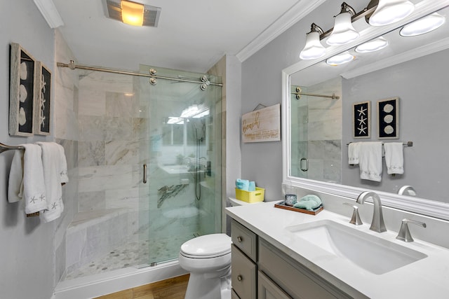 bathroom with ornamental molding, vanity, wood-type flooring, toilet, and a shower with shower door