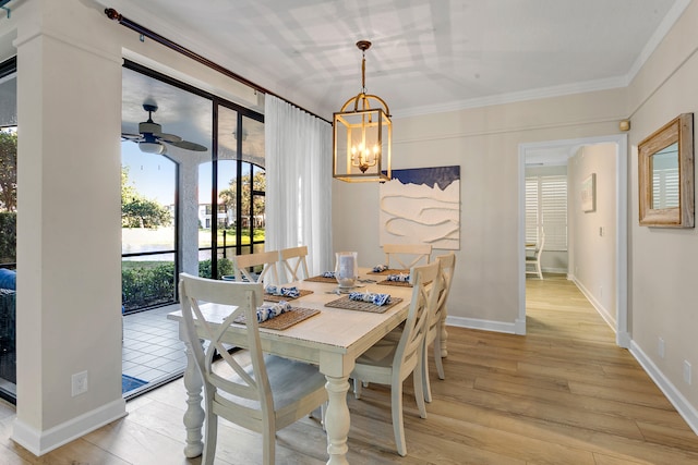 dining area with ceiling fan with notable chandelier, ornamental molding, and light hardwood / wood-style flooring