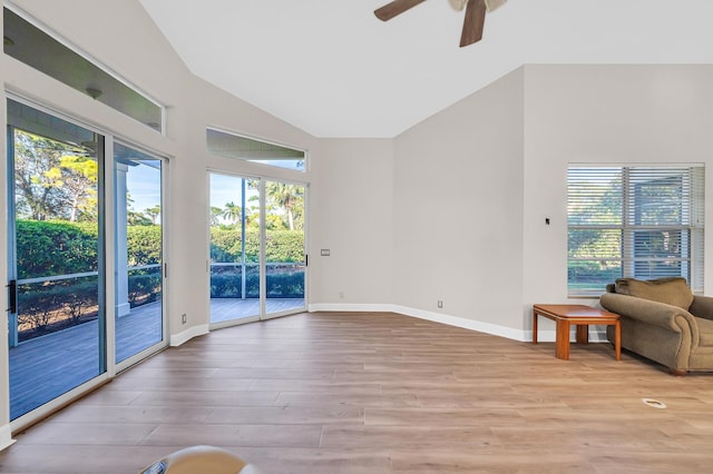 unfurnished living room with ceiling fan, light hardwood / wood-style floors, and vaulted ceiling