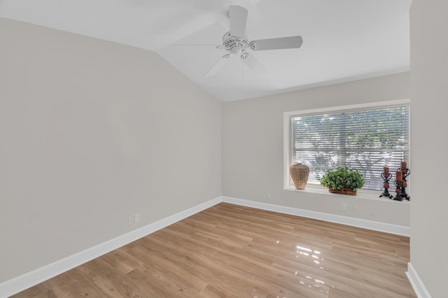 empty room with light wood-type flooring, ceiling fan, and lofted ceiling