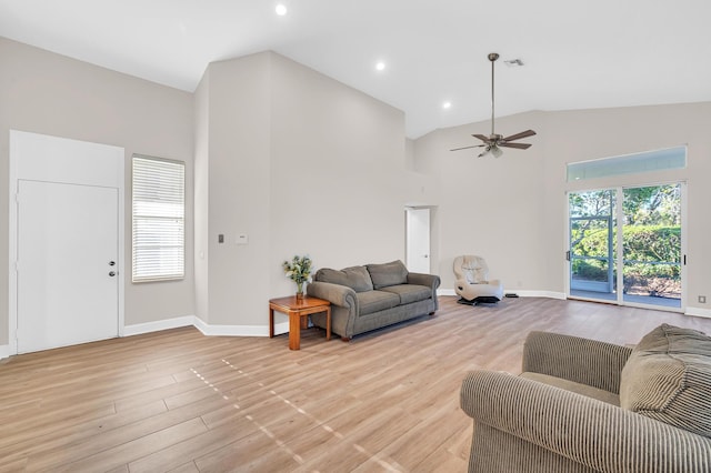 living room featuring ceiling fan, light hardwood / wood-style floors, and high vaulted ceiling