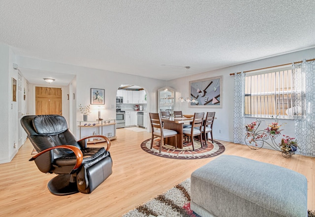 living room with light hardwood / wood-style flooring and a textured ceiling