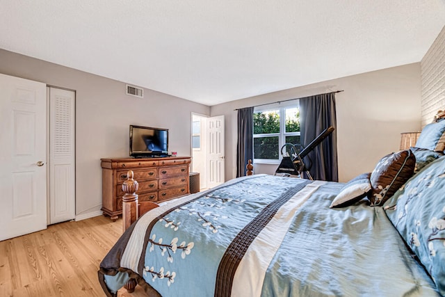 bedroom featuring a closet and light wood-type flooring