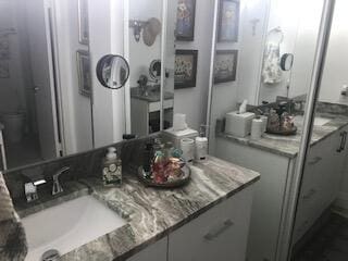 bathroom featuring vanity and toilet